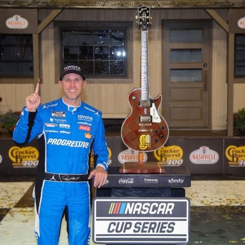 Denny Hamlin celebrates his Cracker Barrel 400 win in Nashville Superspeedway Victory Lane Sunday. The track presents a custom Gibson Guitar to each winner.